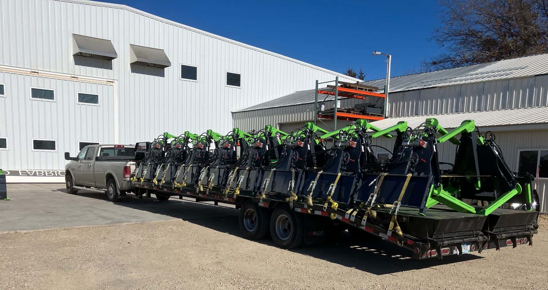Multiple ECHO Handler X3 skid steer tire handlers loaded on flatbed ready for delivery