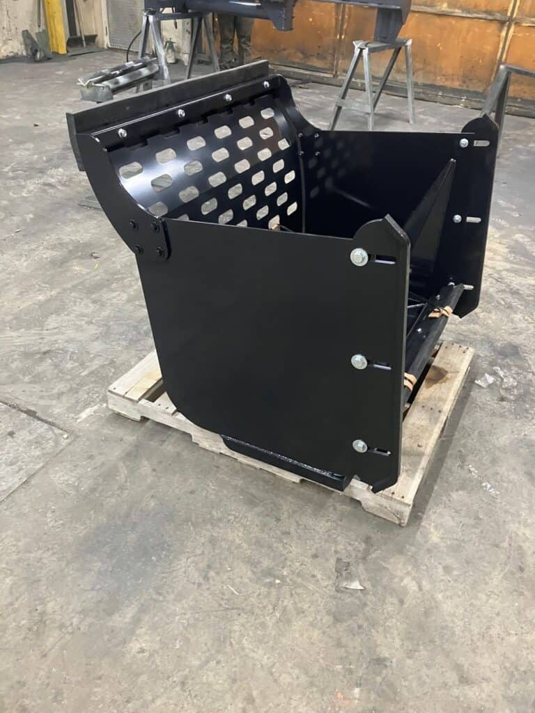 Front bucket area of ECHO CTP compact tractor pusher attachment showing heavy duty side plates