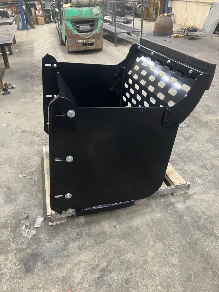 Rear interior view of ECHO CTP compact tractor pusher attachment inside fabrication shop
