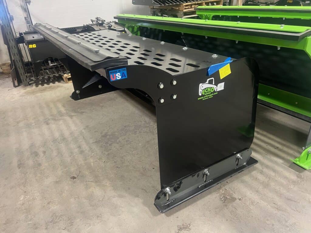 Side angle view of ECHO CTP compact tractor pusher attachment with perforated steel side plates