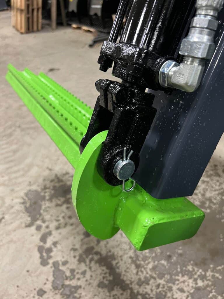 Close up ECHO Handler X3 skid steer tire handler showing hydraulic legs and heavy duty tire grabber frame