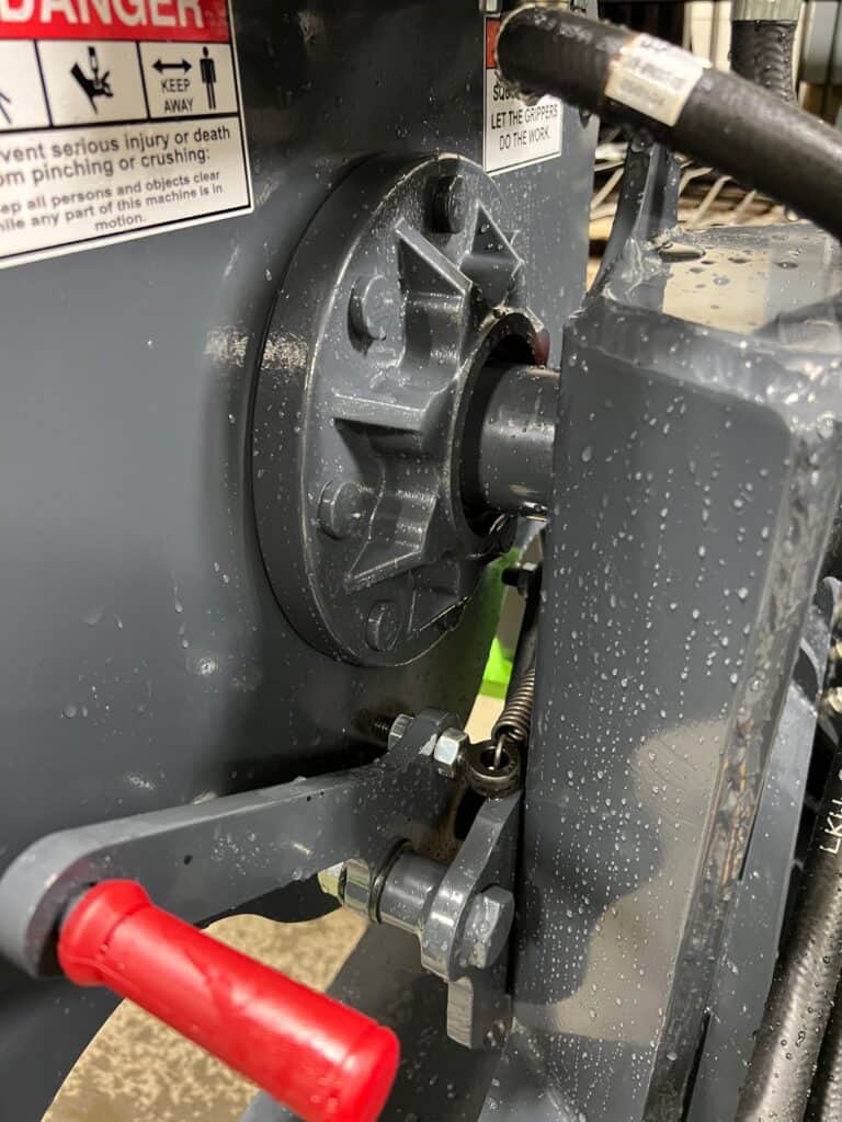 Close up skid steer tire handler showing 8,000 lb spindle and hydraulic rotation system