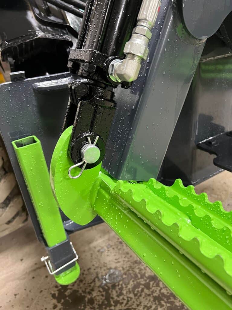 Detail shot hydraulic skid steer tire handler attachment for tractor tire installation