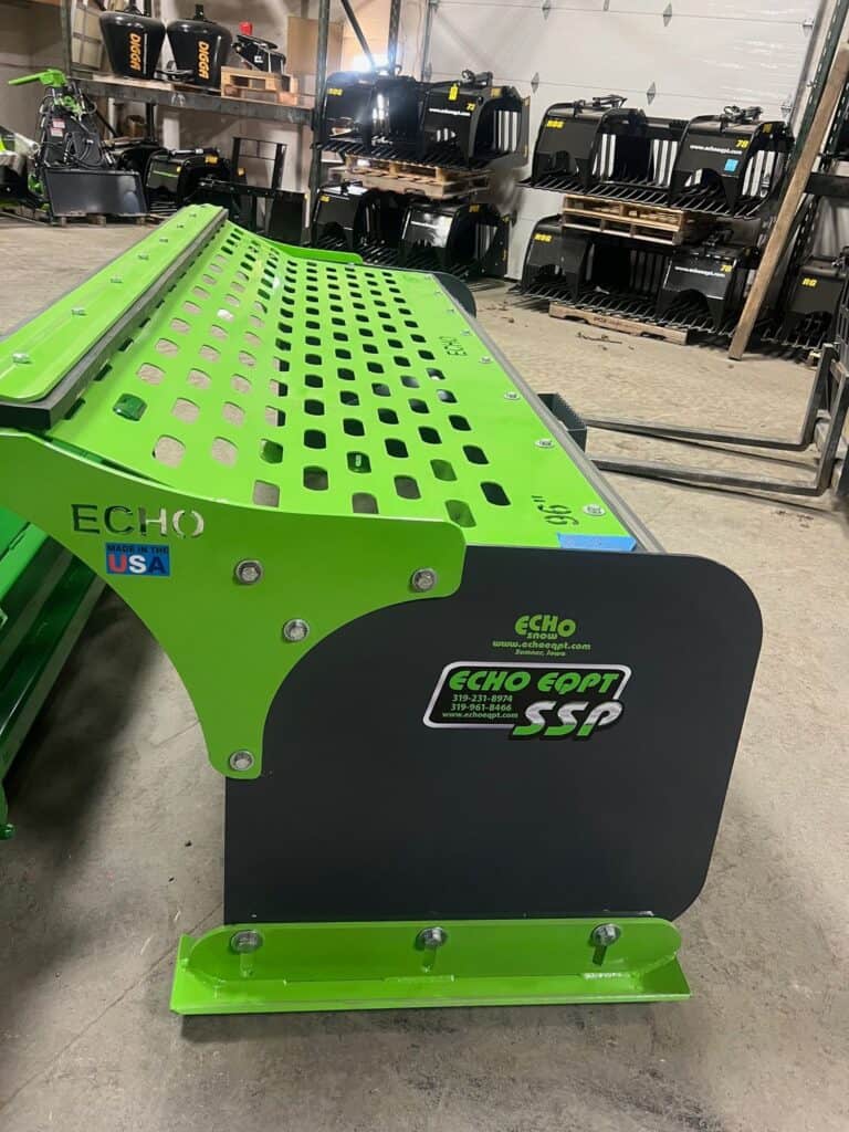 Top view perforated steel back plate on ECHO SSP skid steer snow pusher attachment at equipment yard