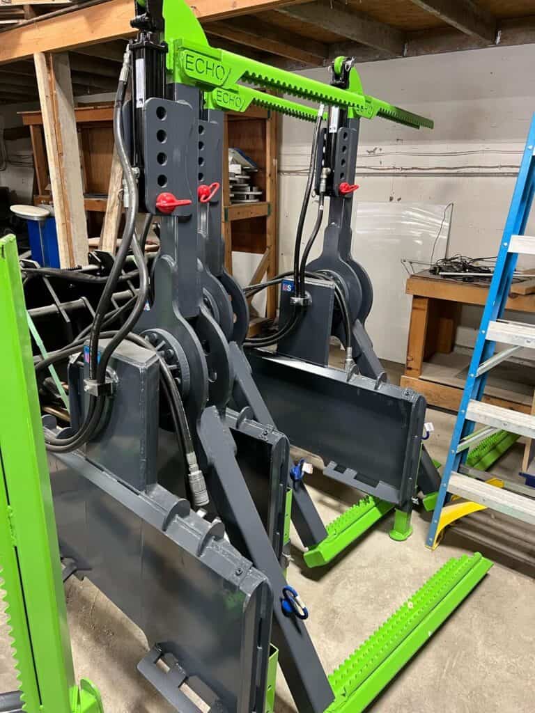 ECHO OG skid steer tire handler attachment with adjustable boom arm inside shop
