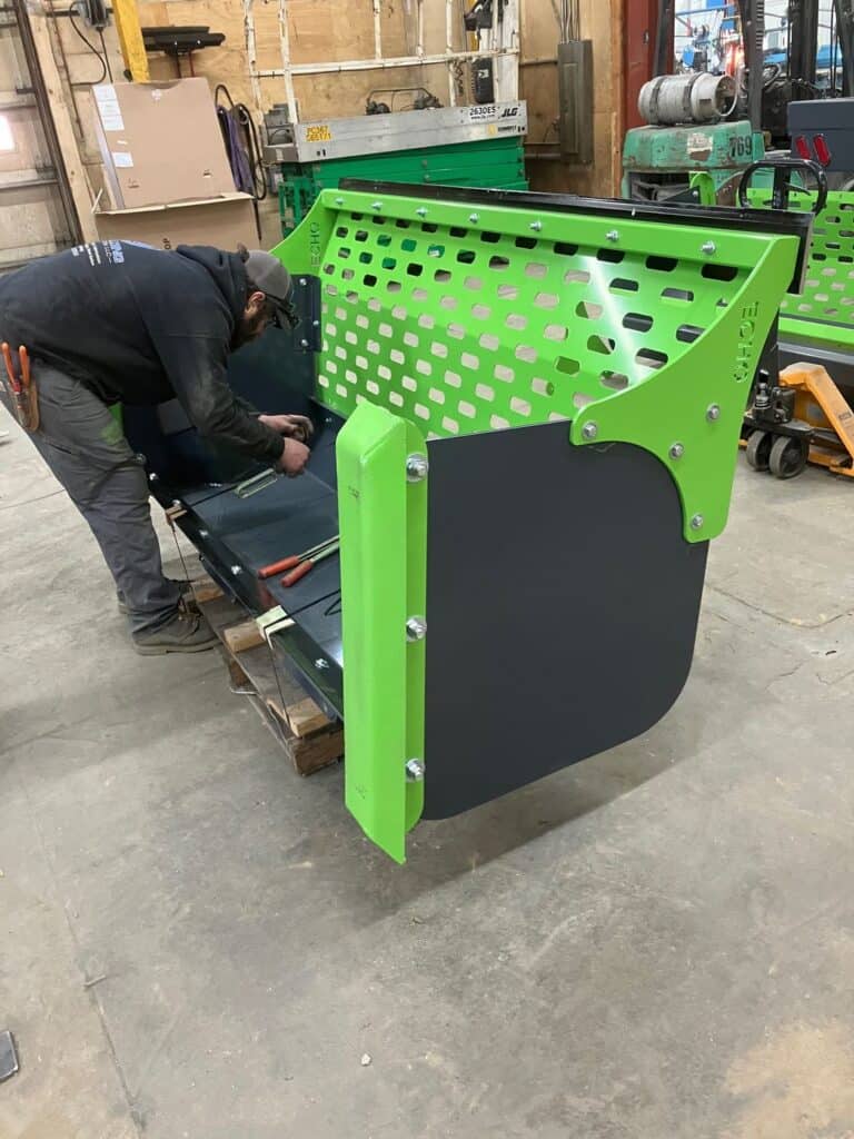 Close up assembly of ECHO SSP skid steer snow pusher attachment with perforated steel back plate