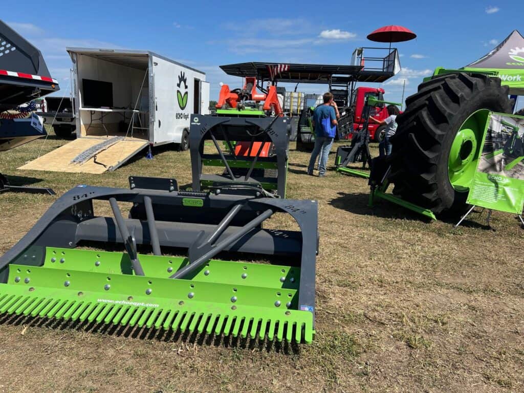 ECHO PG3 skid steer power grader attachment displayed at equipment trade show