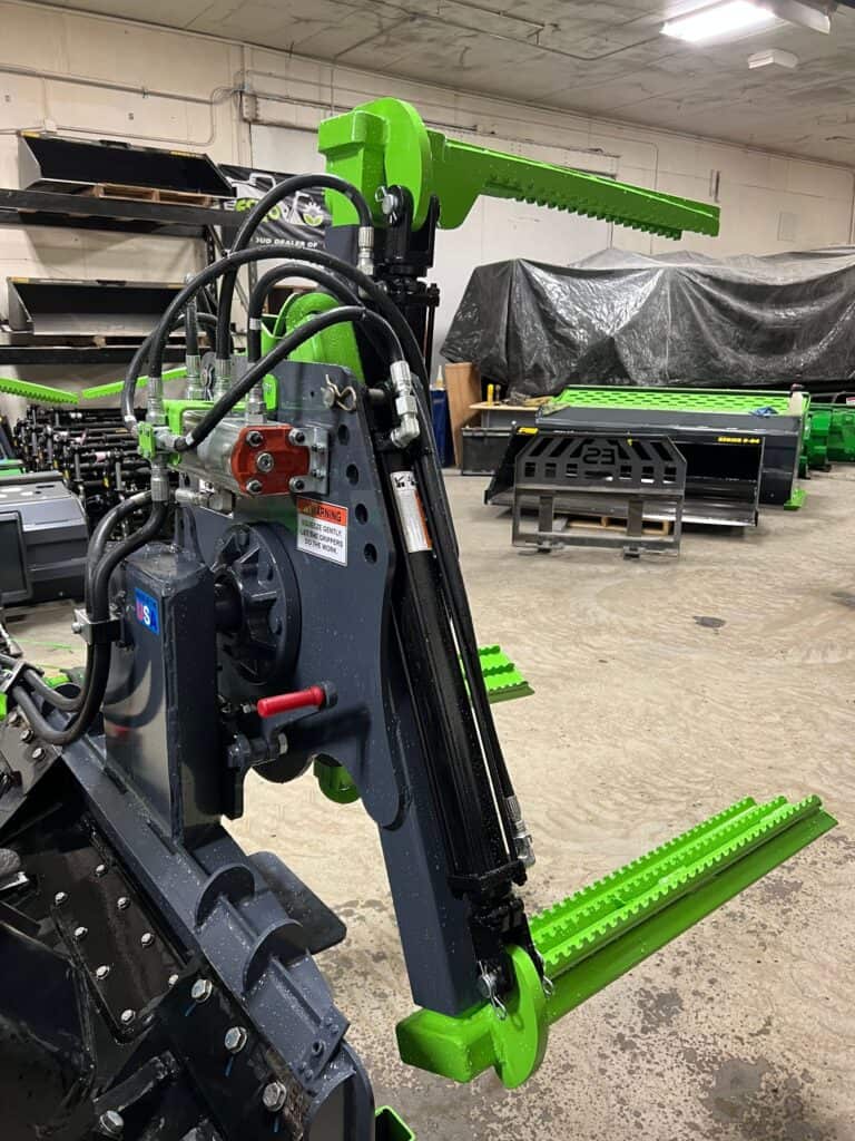 Close up skid steer tire grabber attachment used for installing large farm equipment tires