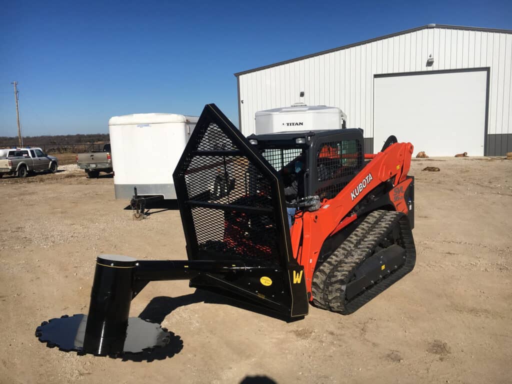 Front view of M&M Hydra Saw attachment mounted on Kubota SVL95 compact track loader