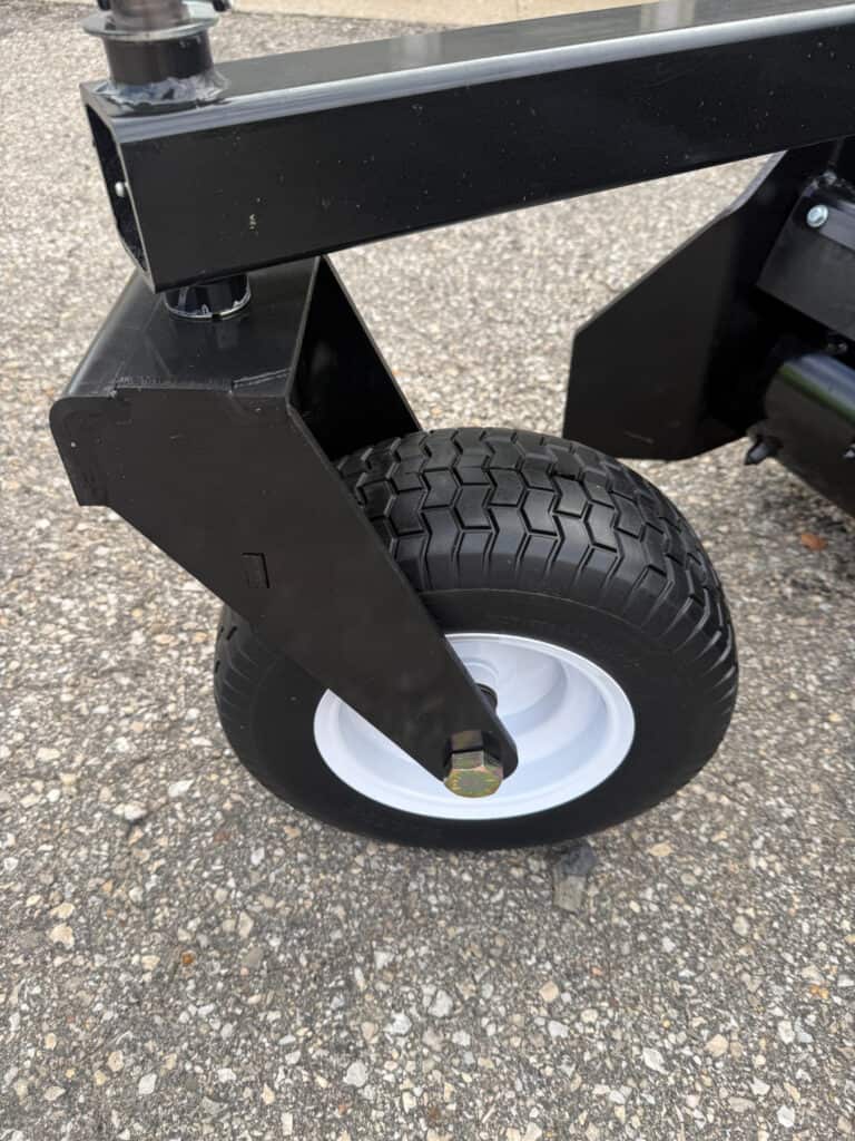 Close-up of PRIME soil conditioner adjustable gauge wheel and support arm