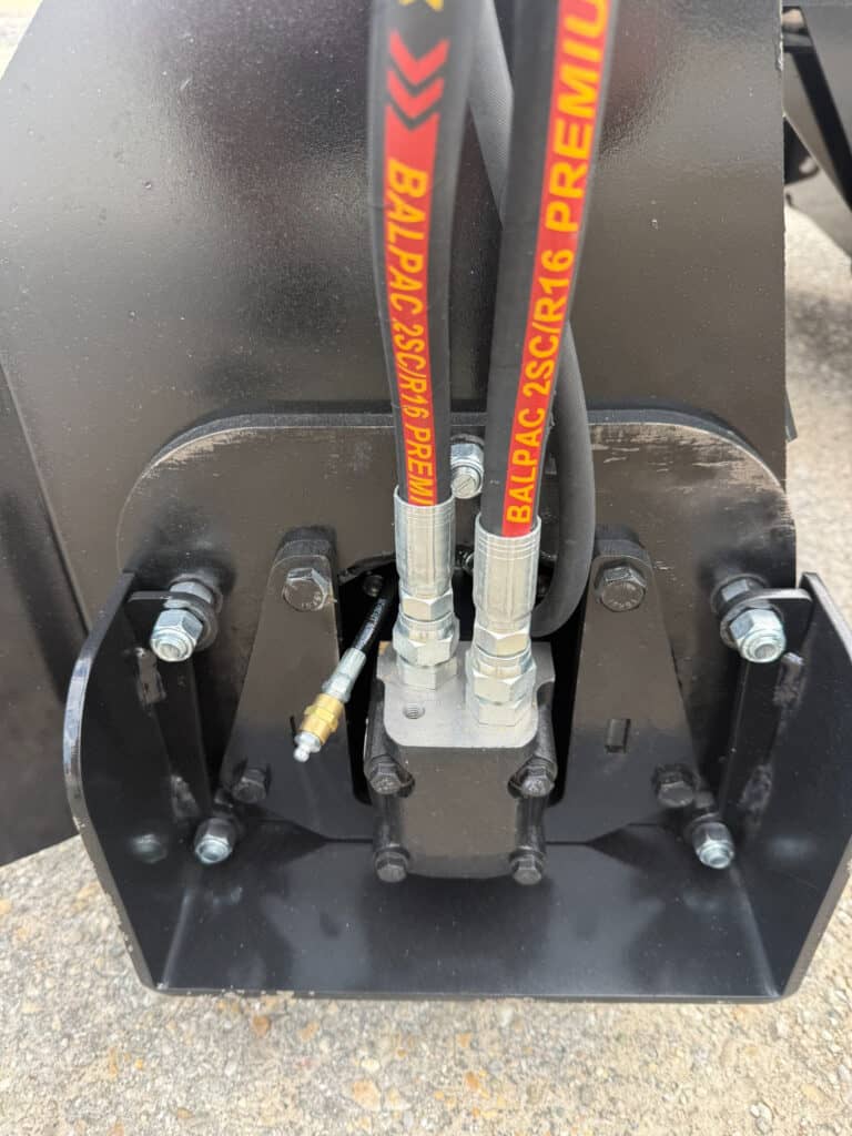 Close-up of PRIME soil conditioner hydraulic hoses and motor connection on the attachment side