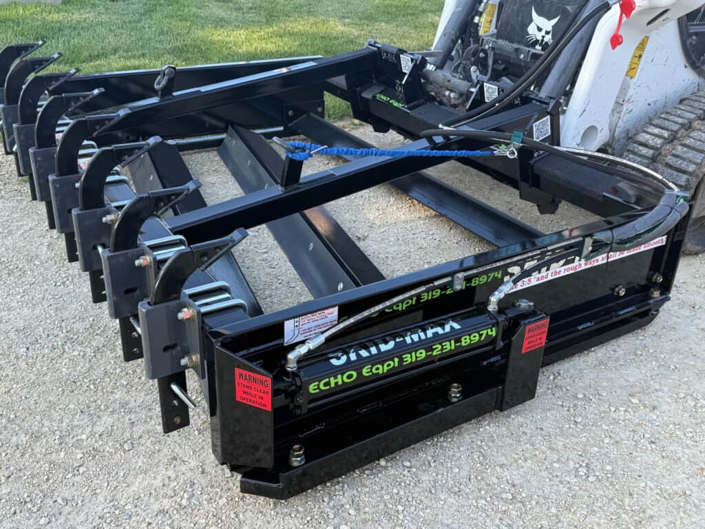 right view of black Skid Max 3 blade hydraulic skid steer grader attachment