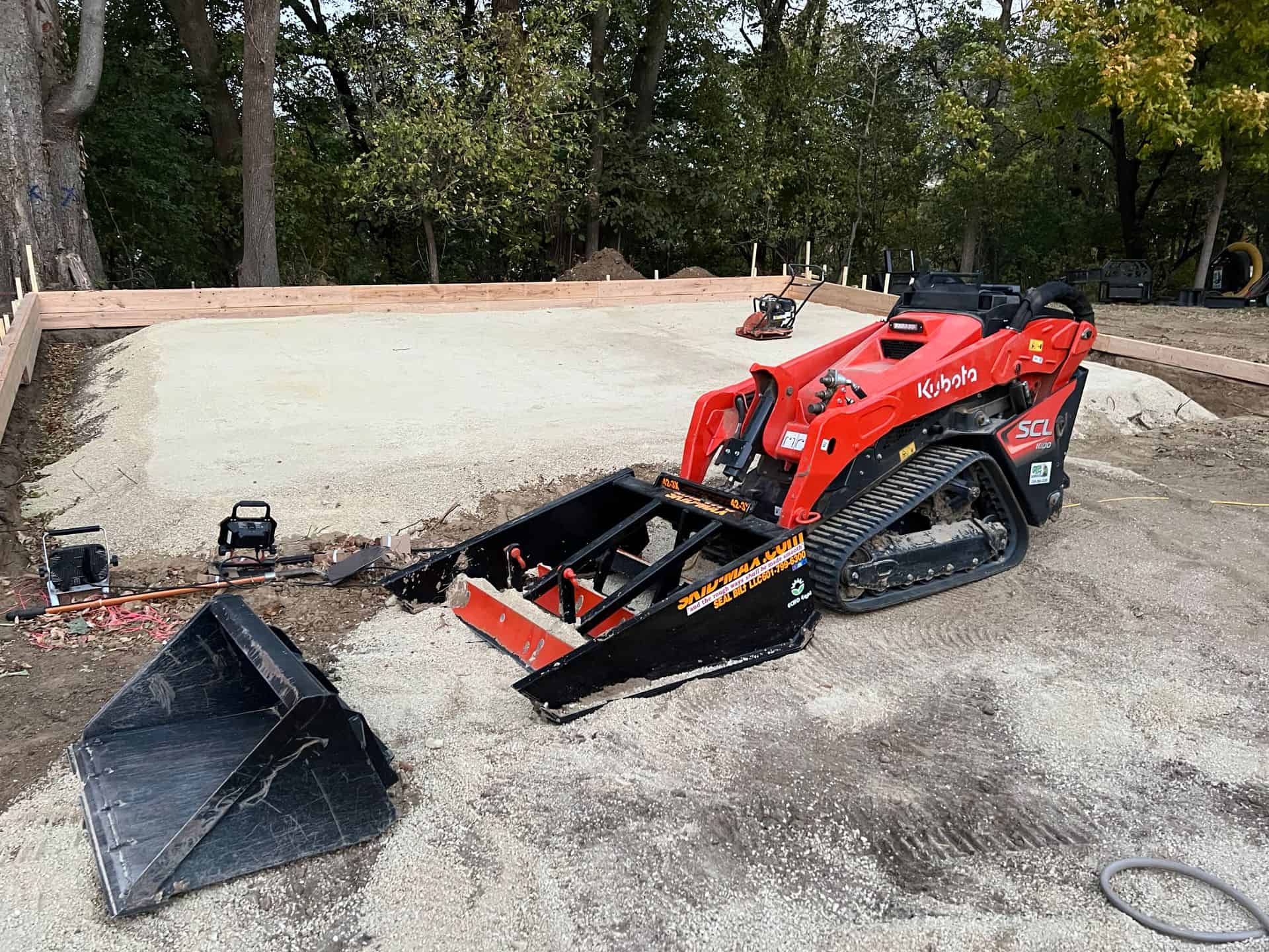 Skid-Max 3X mini skid steer dirt and gravel grader mounted on Kubota showing compact grading capability