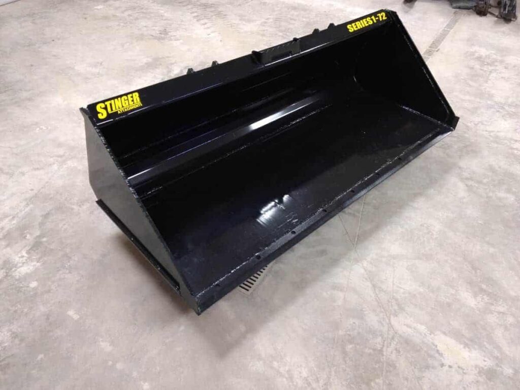 Angled view of Stinger Series 1 72 inch skid steer bucket showing welded side plates and heavy duty bucket construction.