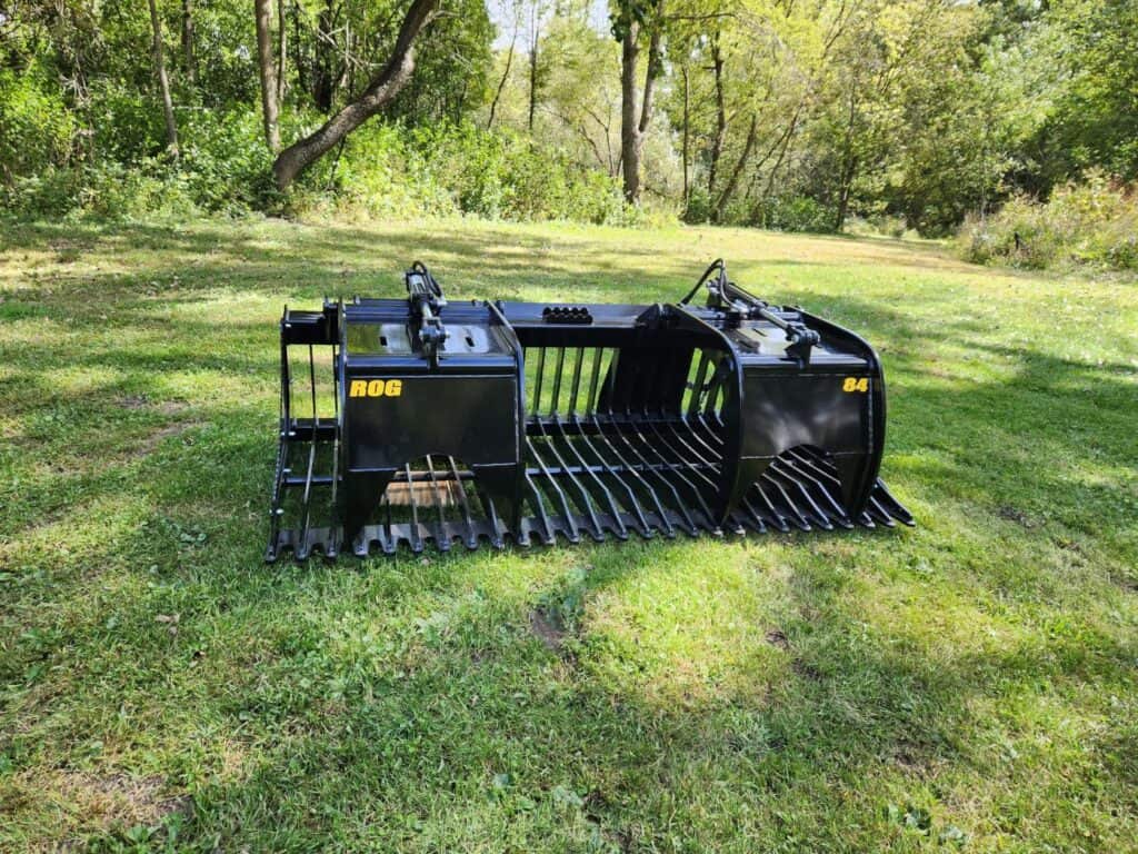 Stinger ROG skid steer rock grapple front view showing tine spacing for handling rocks, brush, and debris