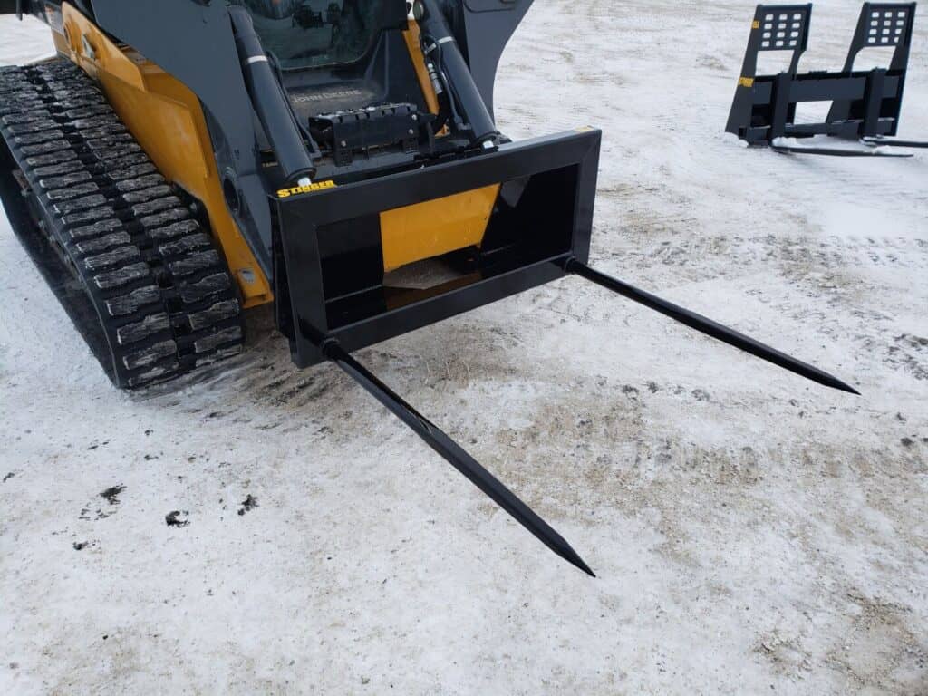 Stinger BS2 skid steer bale spear side view mounted on skid steer showing frame design and spear alignment