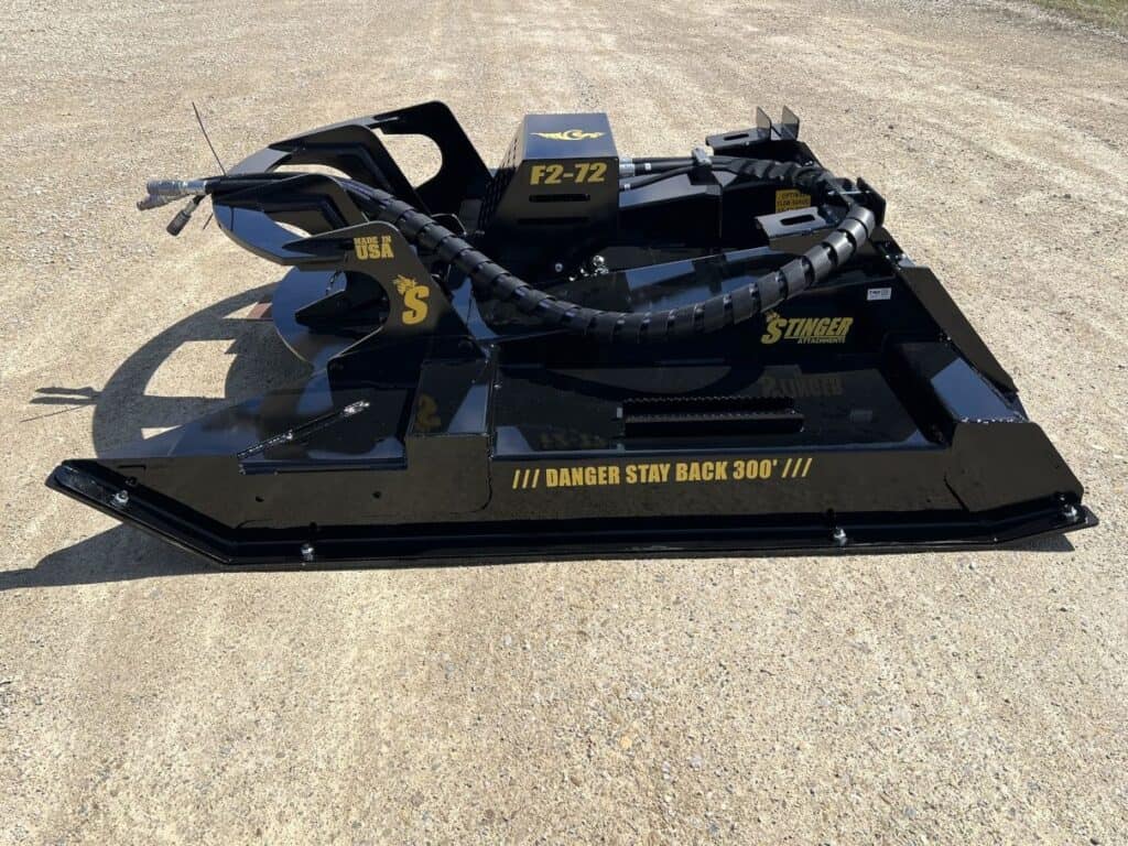 Side profile of Stinger Twister F2 skid steer brush cutter attachment outdoors