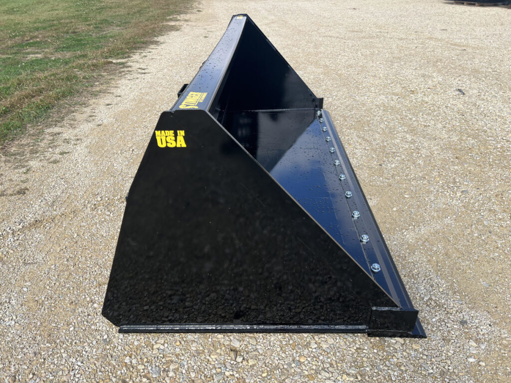 Front left side view of Stinger SNB skid steer snow bucket showing deep shell, cutting edge, and reinforced side wall