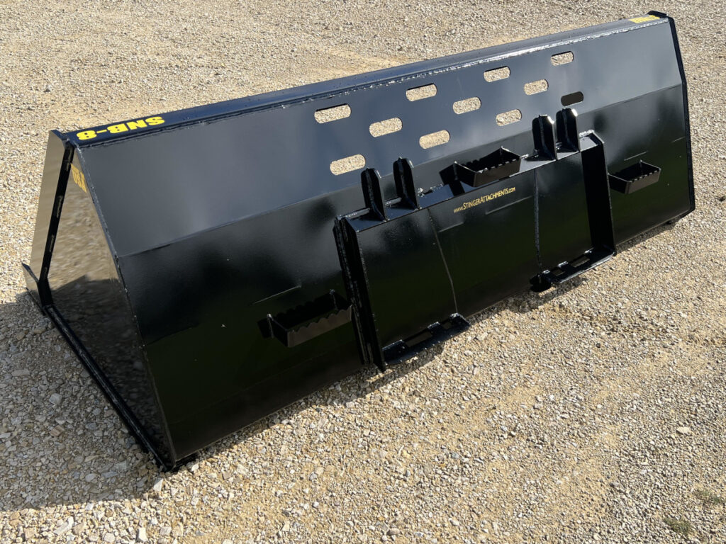 Rear left side view of Stinger SNB skid steer snow bucket showing quick attach mount, steps, and deep bucket shell
