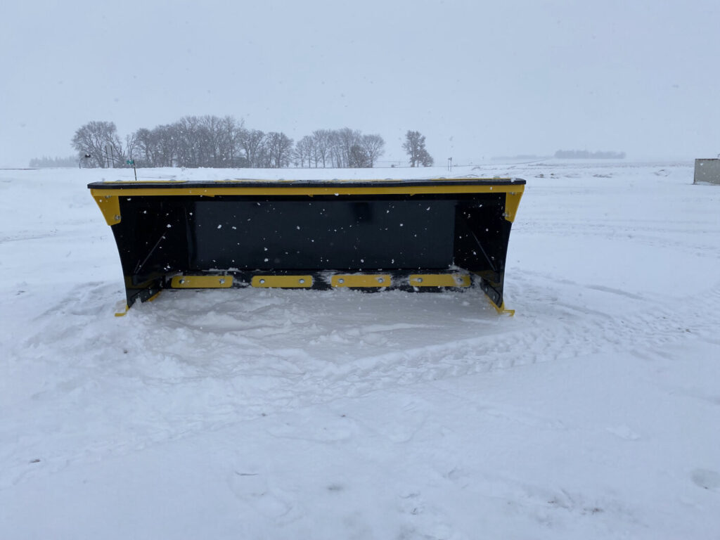 Front view of Stinger SPX8 snow pusher showing wide box and replaceable cutting edges