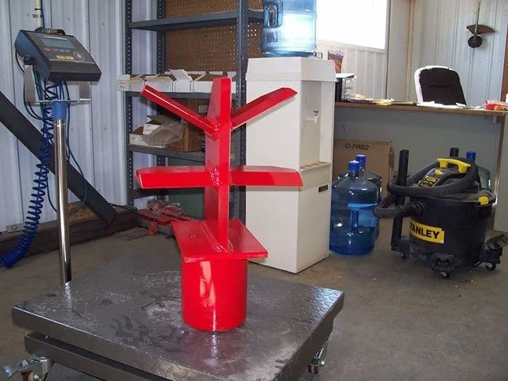 Side view of TM Manufacturing Pro 2 skid steer log splitter attachment in workshop