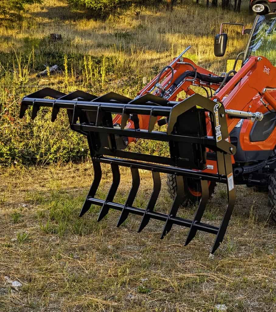 Close-up of the open ANBO CLASP-IT mechanical grapple showing the upper rake and lower grapple tines