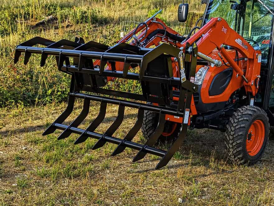 Front angle view of the ANBO CLASP-IT mechanical grapple fully open on a Kioti compact tractor