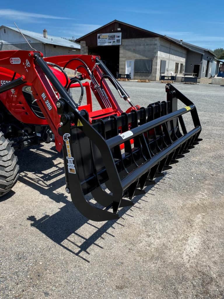 ANBO GR45 grapple rake mounted on a Branson tractor showing the hydraulic grapple and heavy duty rake tines