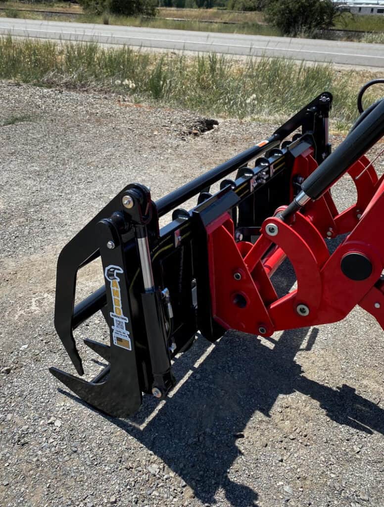 Close-up of the ANBO GR45 grapple rake hydraulic cylinder, pivot points and tractor loader mounting system
