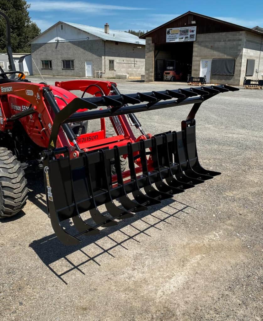 ANBO GR45 grapple rake shown open from an angle on a Branson tractor for brush, logs, rocks and debris handling