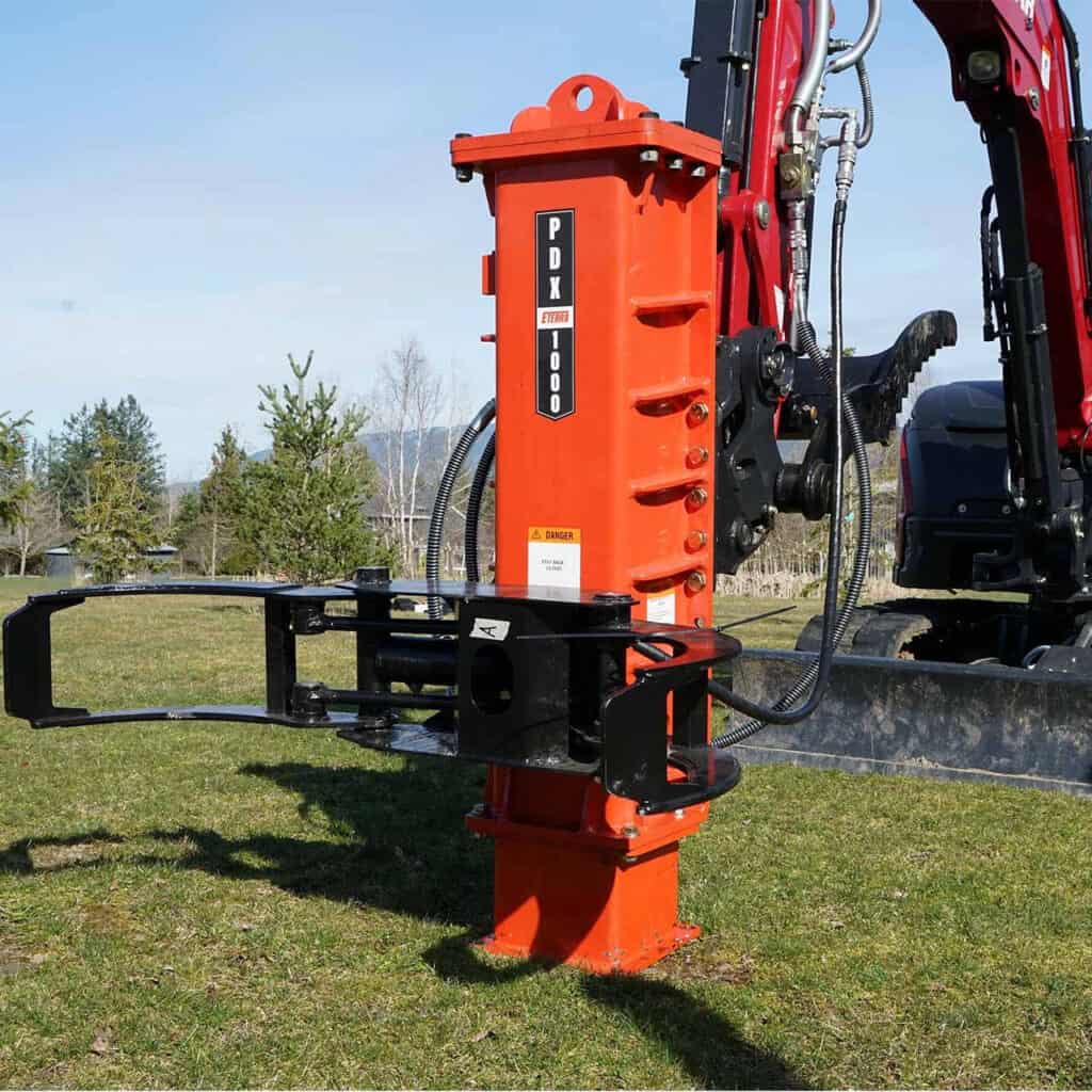 Eterra PDX-1000 hydraulic post driver mounted on a compact excavator with post-grabbing attachment