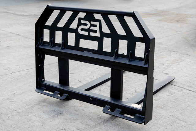 Express Steel heavy duty skid steer pallet fork frame shown from an angle with reinforced backrest and fork carriage