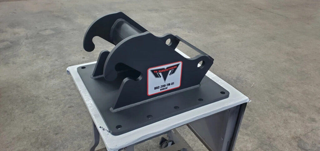TM Manufacturing Bobcat excavator coupler mount for attaching a hydraulic log splitter