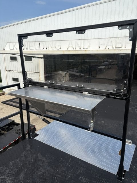 Front view of the ECHO SS Drone Dock clear shield and fold-down stainless work shelf on the upper platform