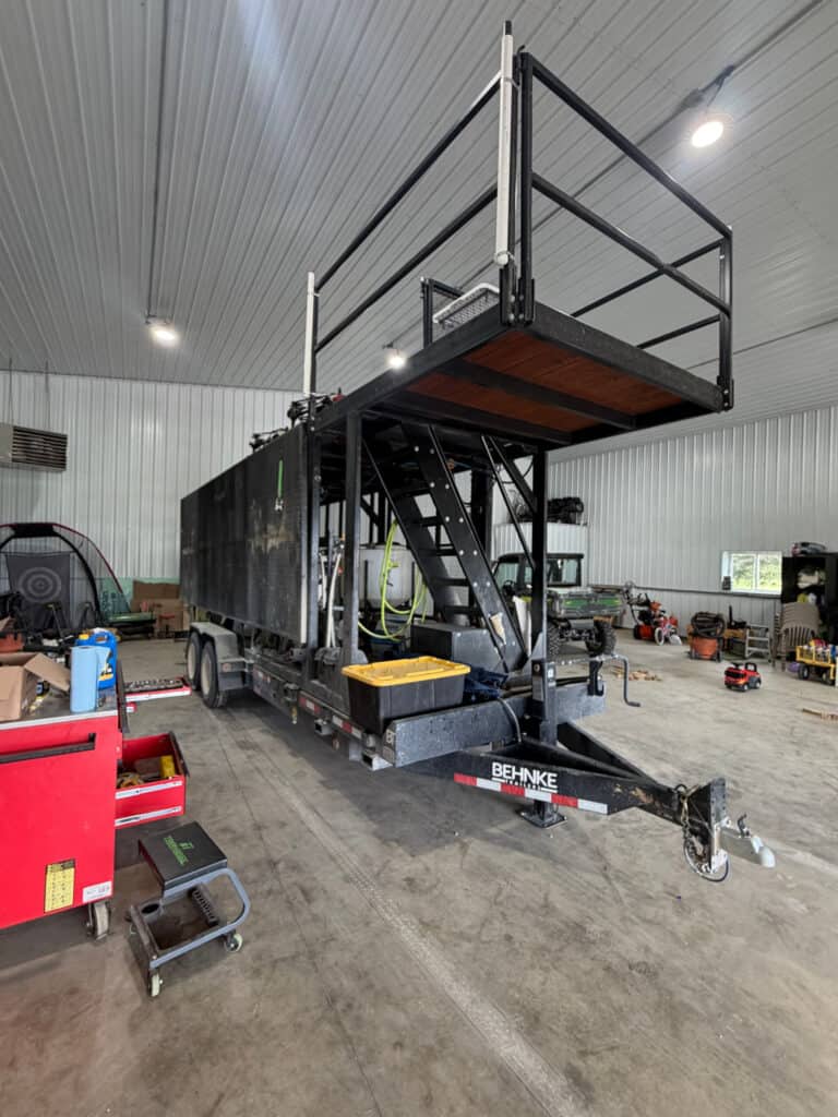 ECHO SS Drone Dock removable trailer platform indoors showing the elevated deck, stairs and safety rail system