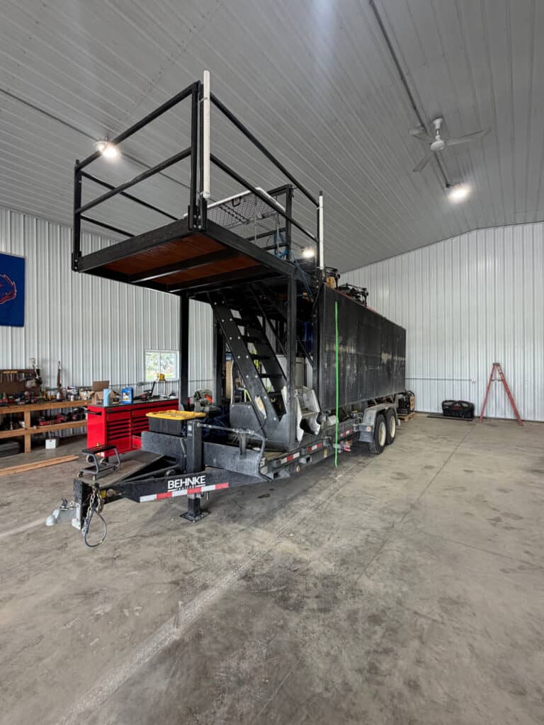 ECHO SS Drone Dock removable trailer platform shown indoors with elevated deck, access stairs and trailer-mounted frame