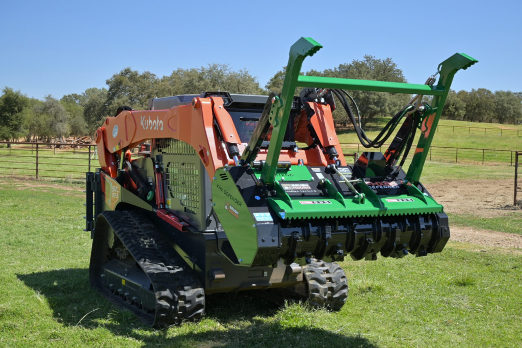 Angled view of the BrushHound FHX66 Defender Forestry Mulcher raised on a skid steer.