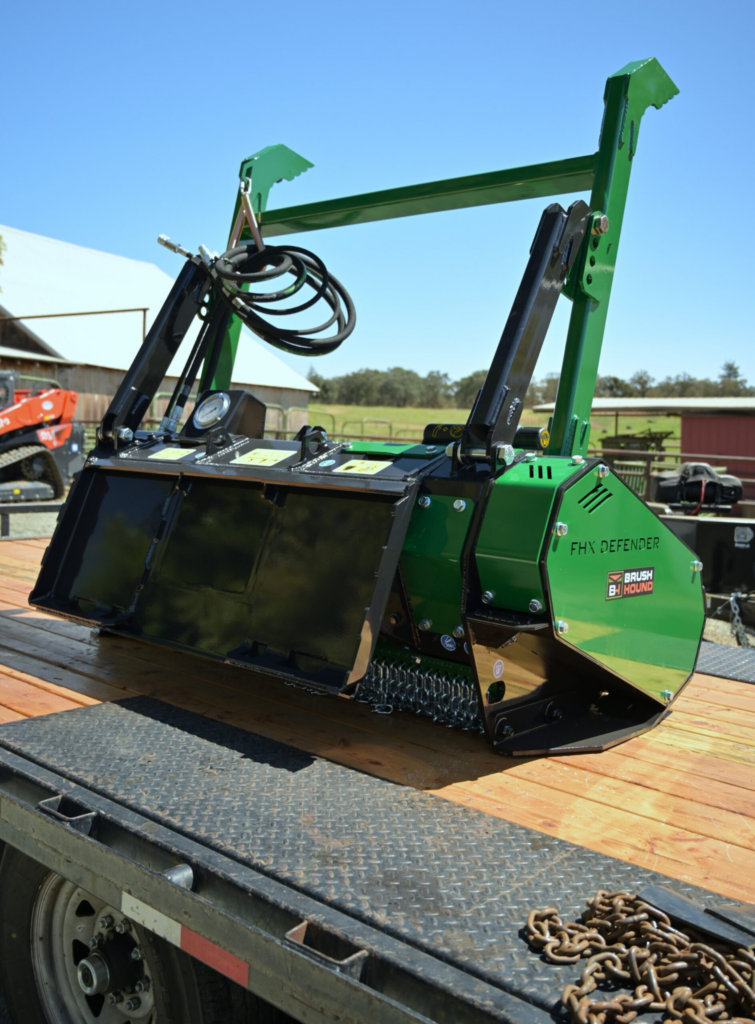 Rear view of the BrushHound FHX66 Defender Forestry Mulcher showing the adjustable ejection door and hydraulic system.