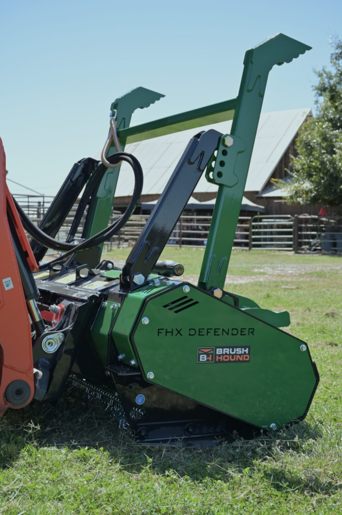 Side profile of the BrushHound FHX66 Defender Skid Steer Forestry Mulcher with hydraulic tree bumper.