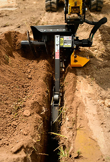 Digga Bigfoot 900 skid steer trencher cutting a narrow utility trench in soil