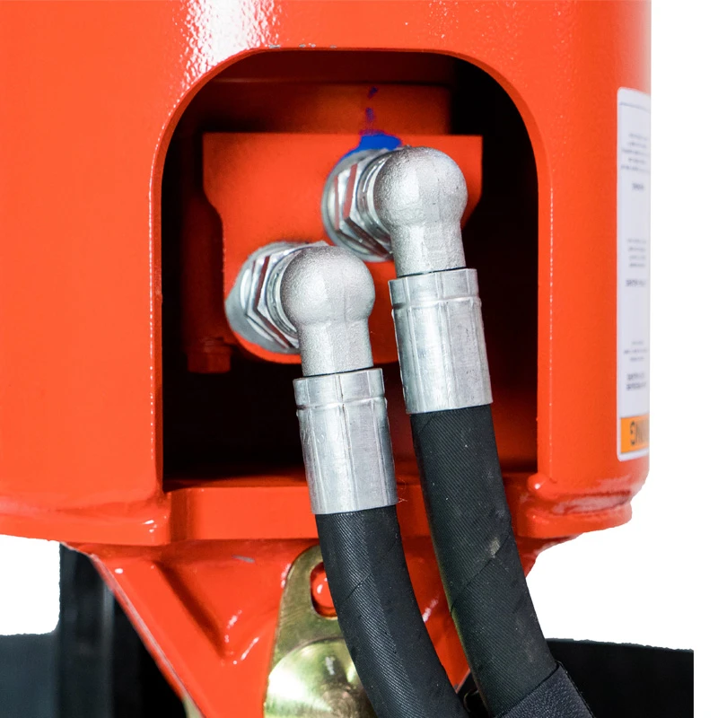 Close-up of hydraulic hose connections on an Eterra excavator auger drive