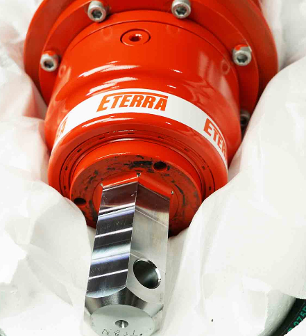 Eterra excavator auger drive close-up showing the output shaft and drive housing