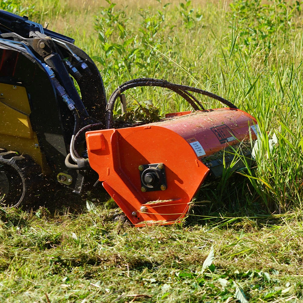 Eterra Sidewinder mini skid steer flail mower cutting tall grass and vegetation