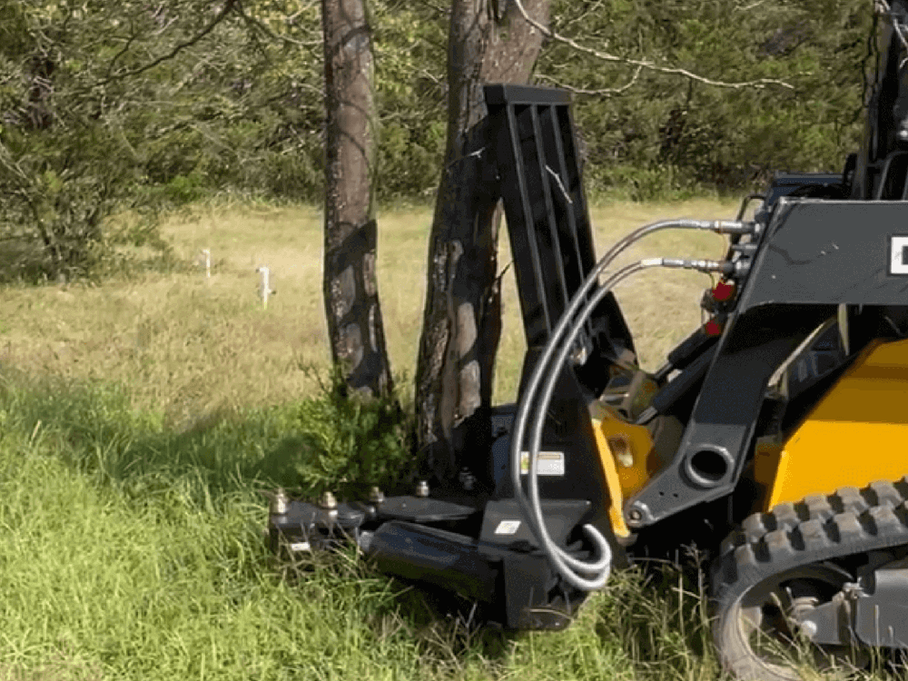 Maxx Attachments 20-inch Ranch Axe tree shear cutting a tree with a skid steer