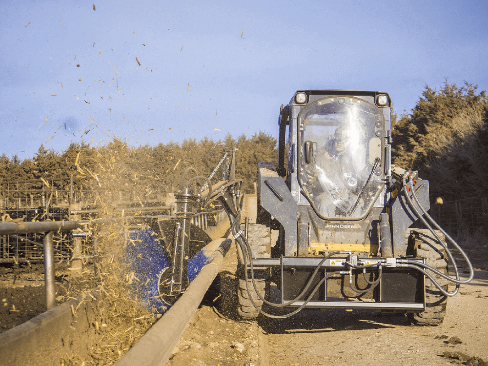 Maxx Attachments Feed Bunk Sweeper clearing leftover feed from a livestock bunk