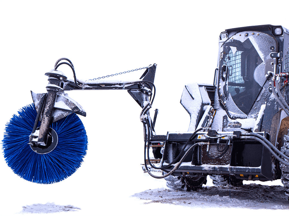 Maxx Attachments Feed Bunk Sweeper mounted on a skid steer for winter feed bunk cleaning