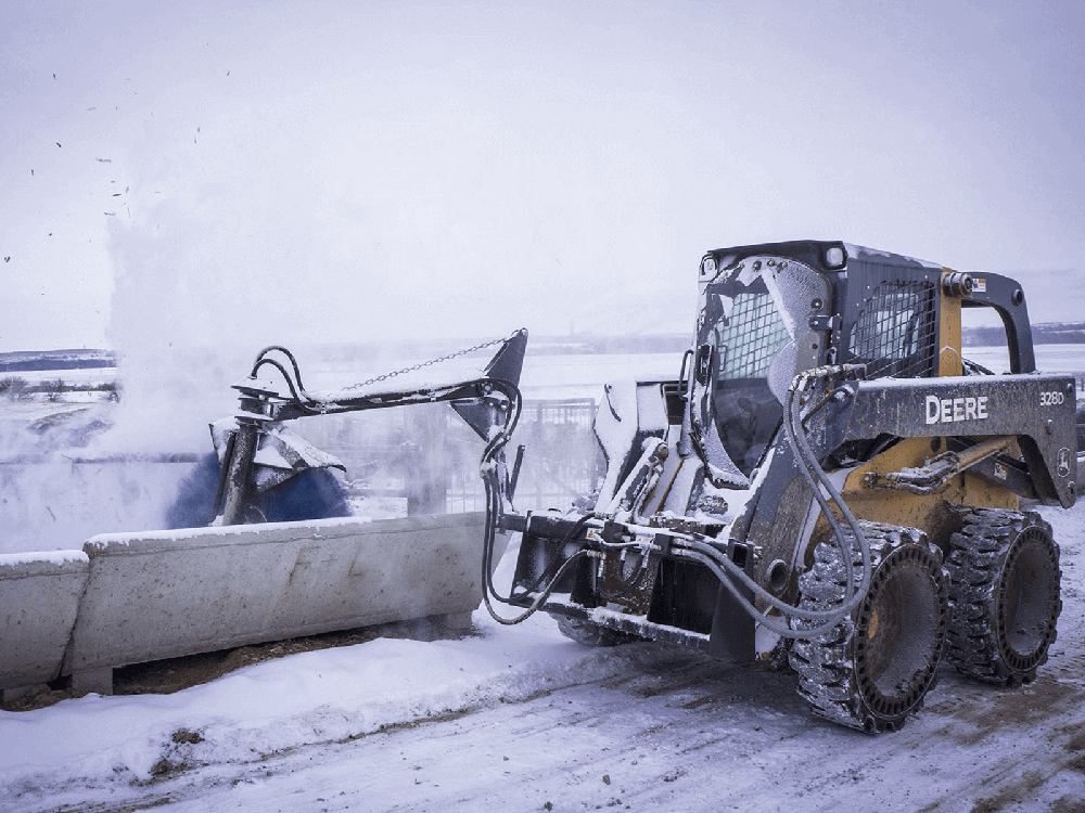 Maxx Attachments Feed Bunk Sweeper removing snow from a feed bunk in winter