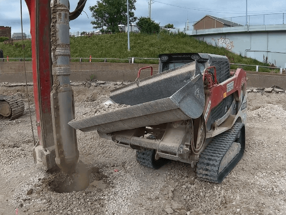 Maxx Attachments Side Dump Bucket mounted on a Takeuchi compact track loader