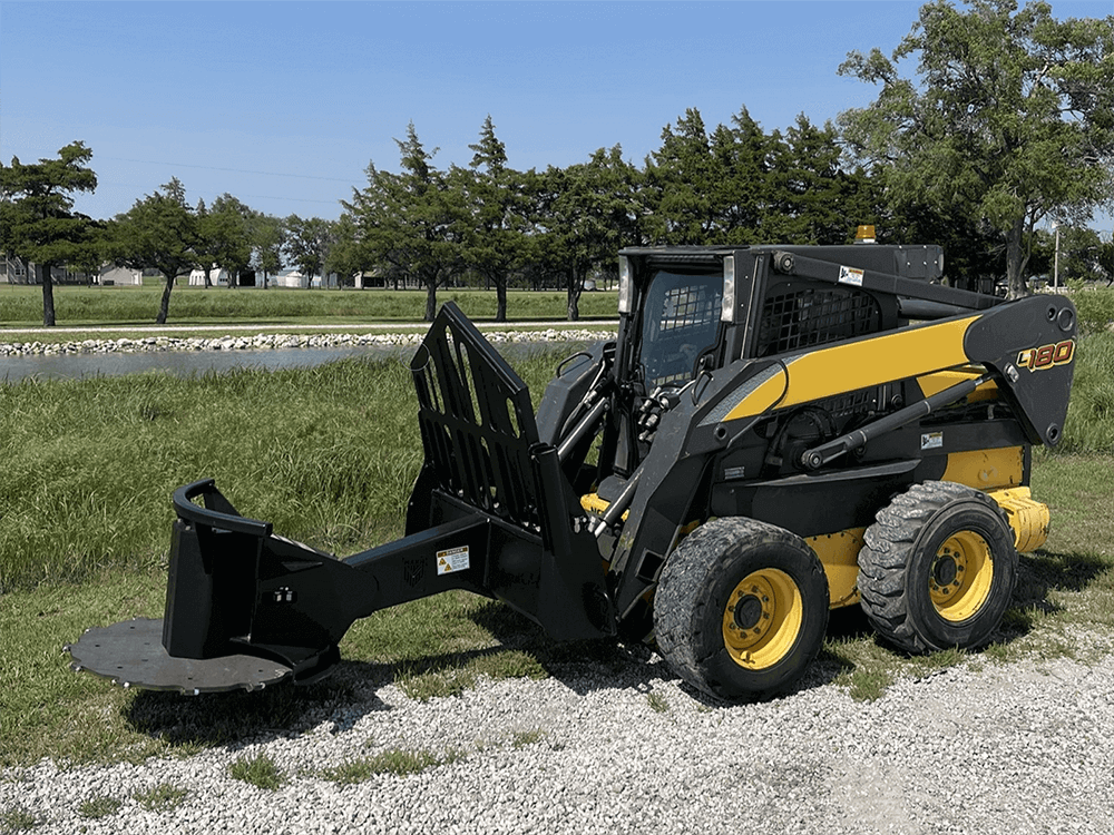Maxx Attachments XD skid steer tree saw mounted on a New Holland skid steer, side view showing boom reach