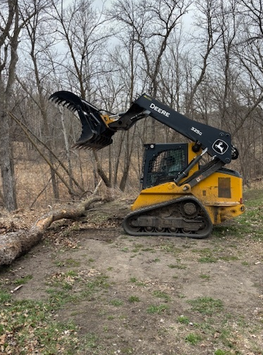 John Deere compact track loader raising a Prime Attachments HD Dual Clam Grapple skid steer attachment
